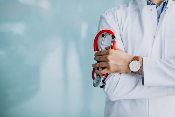 young-handsome-physician-medical-robe-with-stethoscope-min